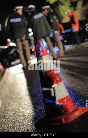 Police behind a traffic cone used to secure the scene of a traffic accident, Gomadingen, Reutlingen Region, Baden-Wuerttemberg, Stock Photo