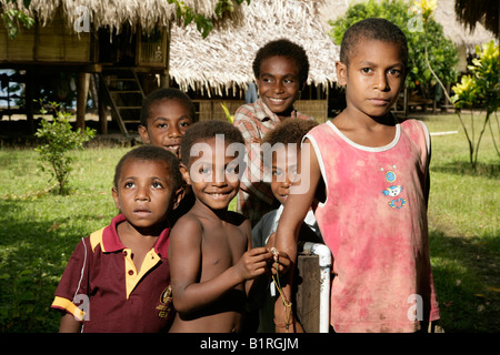 Melanesia, Papua New Guinea. Village of Vanimo. Young boy playing in ...