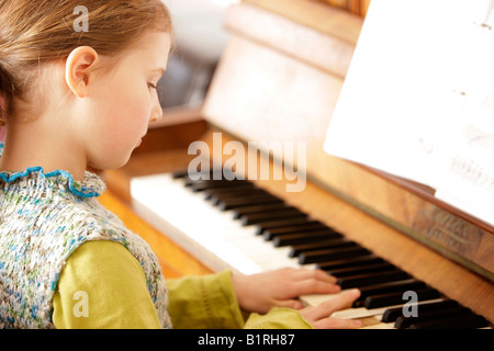 Girl, 8 years old, playing piano Stock Photo