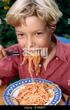 Boy eats spaghetti, appetite Stock Photo