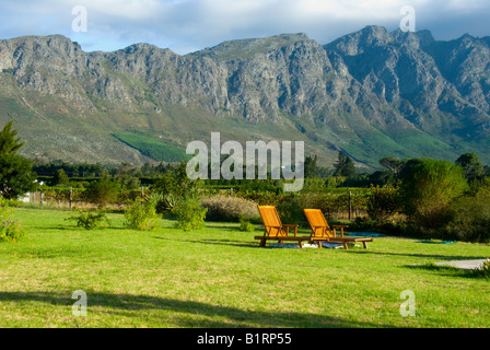 Scenic wine making valley in Franschhoek, South Africa with two deck chair in vast beautiful scenery Stock Photo