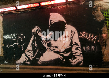 Banksy 'Hooded Man With Knife'.  Banksy graffiti street art on wall. Leake Street Waterloo London, Cans Festival. 2008 2000s HOMER SYKES Stock Photo