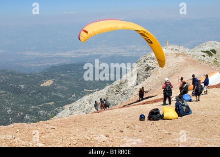 Paragliding off Babadag mountain in Fethiye, Mugla Turkey landing on Olu Deniz Beach, a popular holiday makers Stock Photo