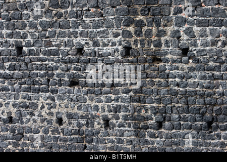 Quarried stone blocks a brick retaining wall in Catania, Sicily, Italy Stock Photo