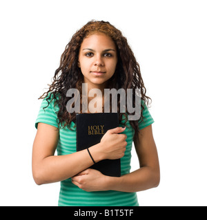 Teen girl holds bible in her hands Stock Photo