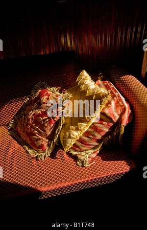 Satin cushions on couch in afternoon sunlight Stock Photo