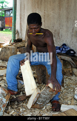 Wood carver at work at the carving centre in Aburi, Eastern Region, Ghana Stock Photo