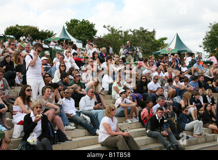 Wimbledon 2008 lots of people sitting in Henman Hill watching a tennis match on centre court on a big screen Stock Photo