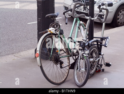 Two bicycles chained to a lamp post in South Kensington, London. Stock Photo