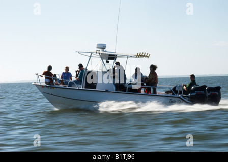 boat powers across Apalachicola Bay, Florida Stock Photo