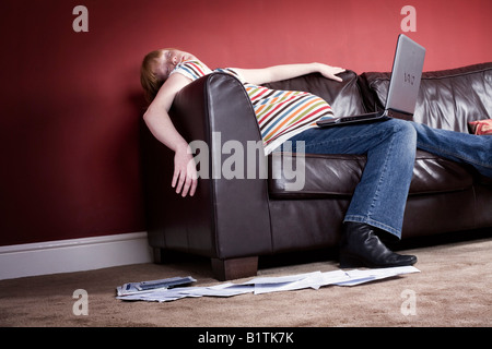 Pregnant Woman falling asleep whilst using a Laptop Stock Photo