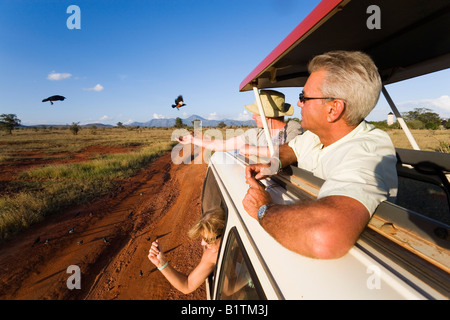 Tourists in a safari bus feeding birds Taita Hills Game Reserve Coast Kenya Stock Photo