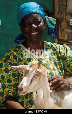 Close up african woman smiling facing camera holding goat Kenya Africa Stock Photo