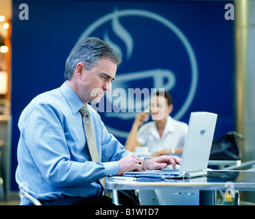 man in cafe with laptop computer Stock Photo