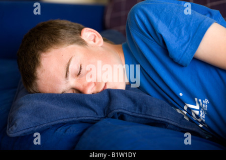 Teenage boy asleep on a sofa Stock Photo - Alamy