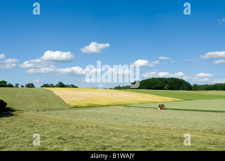 Europe Germany Upper Bavaria farmer on Tractor making hay Stock Photo