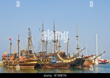 Mock galleon style wooden sailing ships that carry tourists for day cruises along the coast moored in the Hammamet Marina. Stock Photo