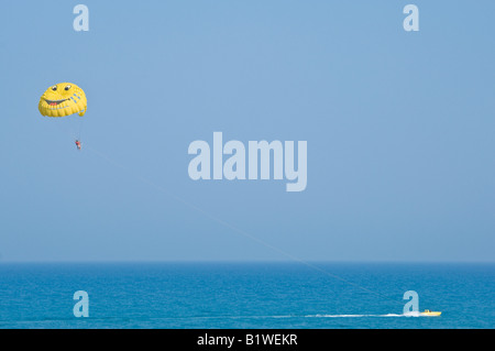 A wide angle view of parasailing near Hammamet in Tunisia on a sunny day against a bright blue sky. Stock Photo