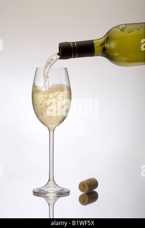 Pouring a glass of white wine Stock Photo