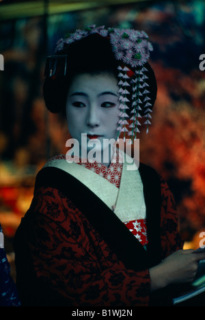 Japanese Geisha wearing a Kimono patterned cherry blossom robe with ...