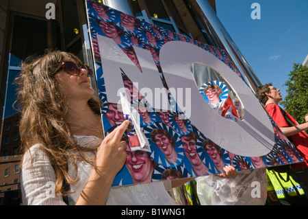 Woman at Stop Airport Expansion Flash Mob at DfT in Westminster against third runway for Heathrow with paper plane Stock Photo