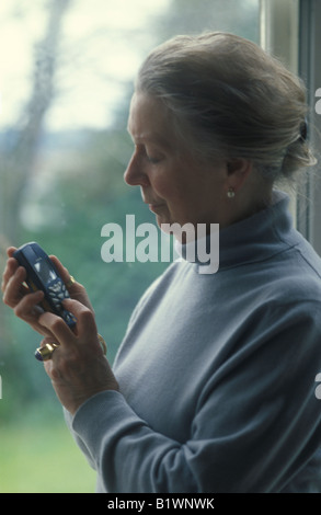 elderly woman using a mobile phone Stock Photo