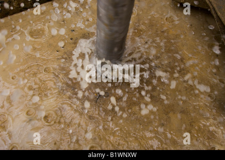 A drill splashes water during a hotel conversion. Stock Photo