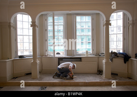 A builder works in an unfinished alcove. Stock Photo