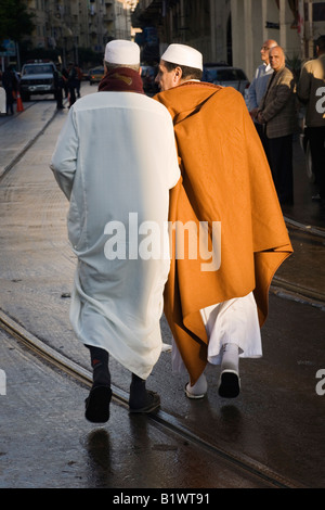 Alexandria, Egypt. Egyptian men wearing full length robe known as the Galabiyya and fez hats Stock Photo