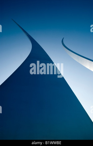 Air Force Memorial Spires Arlington Virginia | ARLINGTON, Virginia — Two of the United States Air Force Memorial's three stainless steel spires cut a sharp diagonal against the sky above the Pentagon. The tallest reaches 270 feet (82 m); its asymmetrical, curving form was designed to evoke the contrails of Air Force Thunderbirds peeling away from a "bomb burst" maneuver. Architect James Ingo Freed of Pei Cobb Freed & Partners completed the design shortly before his death in 2005. Stock Photo