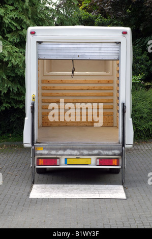 Rear view of an empty white box van with it s tail lift lowered Stock Photo