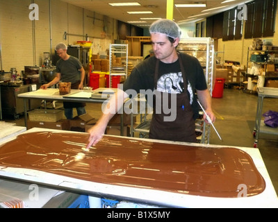 Seattle, Theo Chocolate Factory, 'tempering' chocolate on marble slab Stock Photo