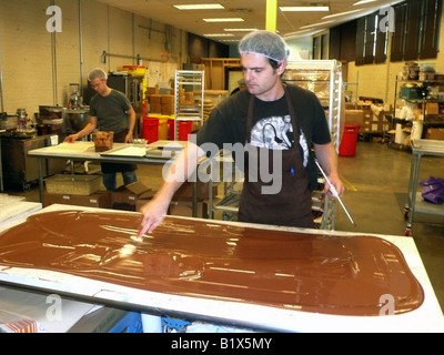 Seattle, Theo Chocolate Factory, "tempering" chocolate on marble slab Stock Photo