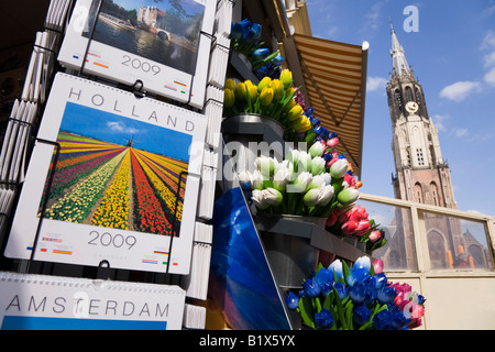 Calendars & tulips for sale at a shop in Markt Square, Delft. Netherland. The tower/spire of the Nieuwe Kerk Cathedral is behind Stock Photo