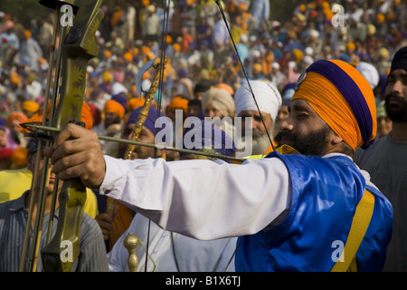 Sikh Nihang warrior displaying his archery skills during Hola Mohalla festival at Anandpur Sahib. Punjab, India Stock Photo
