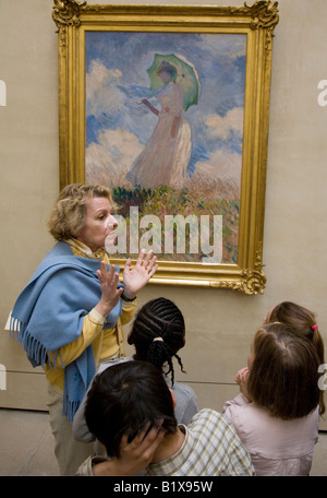 Teacher with young french schoolchildren looking at Monet painting Musee D'Orsay Paris France Stock Photo