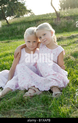 Portrait of two girl friends putting their arms around their shoulders in summer, outdoor exterior Stock Photo