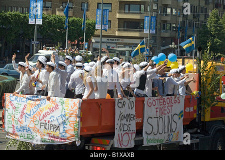 Students ride on truck platform during traditional celebration of High School Graduation Day in Gothenburg Sweden Jun 2008 Stock Photo