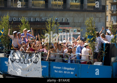 Students ride on truck platform during traditional celebration of High School Graduation Day in Gothenburg Sweden Jun 2008 Stock Photo