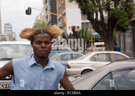 Young black man with  blonded hair working as a car washer. Maputo, Mozambique. Stock Photo