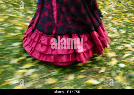 Canada, Montreal, Woman with Victorian dress walking on grass, partial view Stock Photo