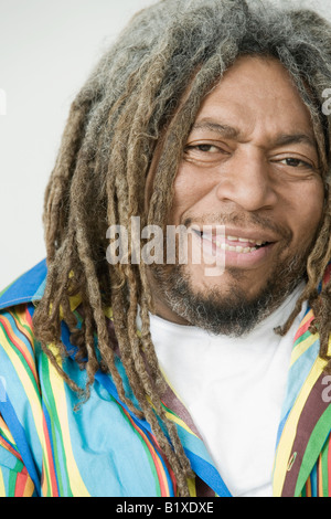 A color vertical image of a rastafarian man inhaling from the burning ...