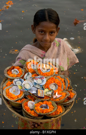 beautiful young girl selling garlands on a ghat in Varanasi, India Stock Photo