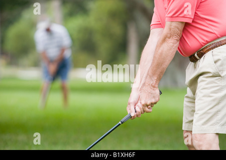 Mid section view of a senior man playing golf Stock Photo