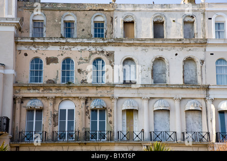 Windows of a neglected sea front building in Folkestone Kent Stock Photo