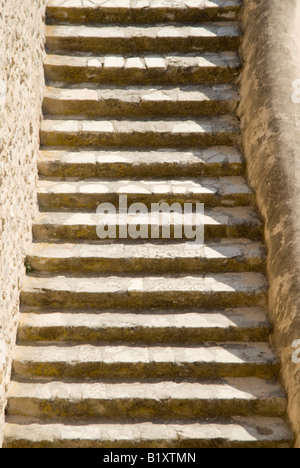 Vertical close up of a flight of old stone steps in the sunshine Stock Photo
