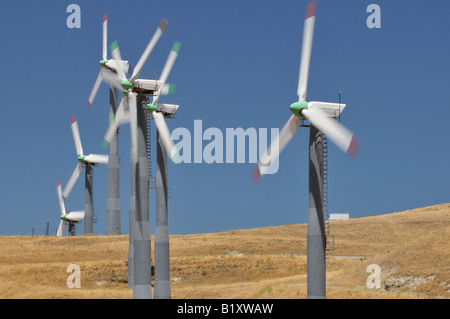 Power generating windmills spin on a ridge near San Francisco California USA Stock Photo