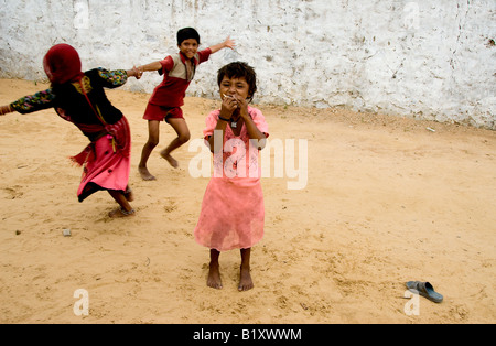 Happy Rajasthani children playing in a courtyard, Thar desert, India. Stock Photo