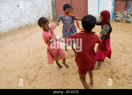 Happy Rajasthani children playing in a courtyard, Thar desert, India. Stock Photo