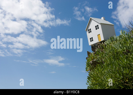 Model house on cliff edge Stock Photo